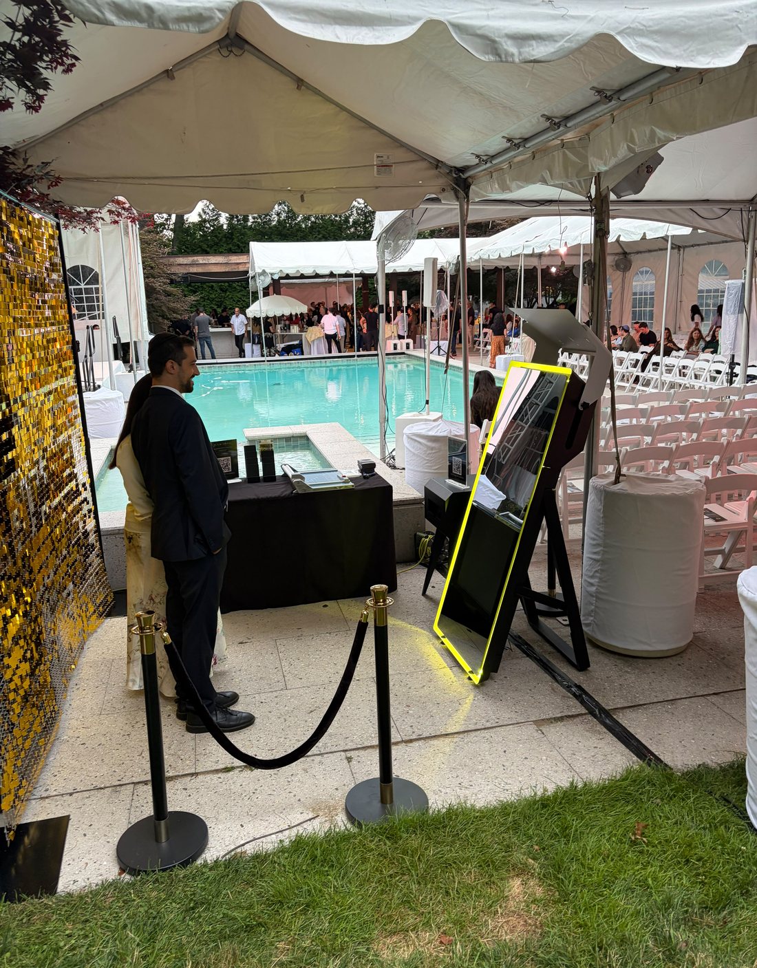 Mabooth luxury mirror photo booth at a poolside simcha, with a professional attendant, velvet ropes, and gold shimmer wall
